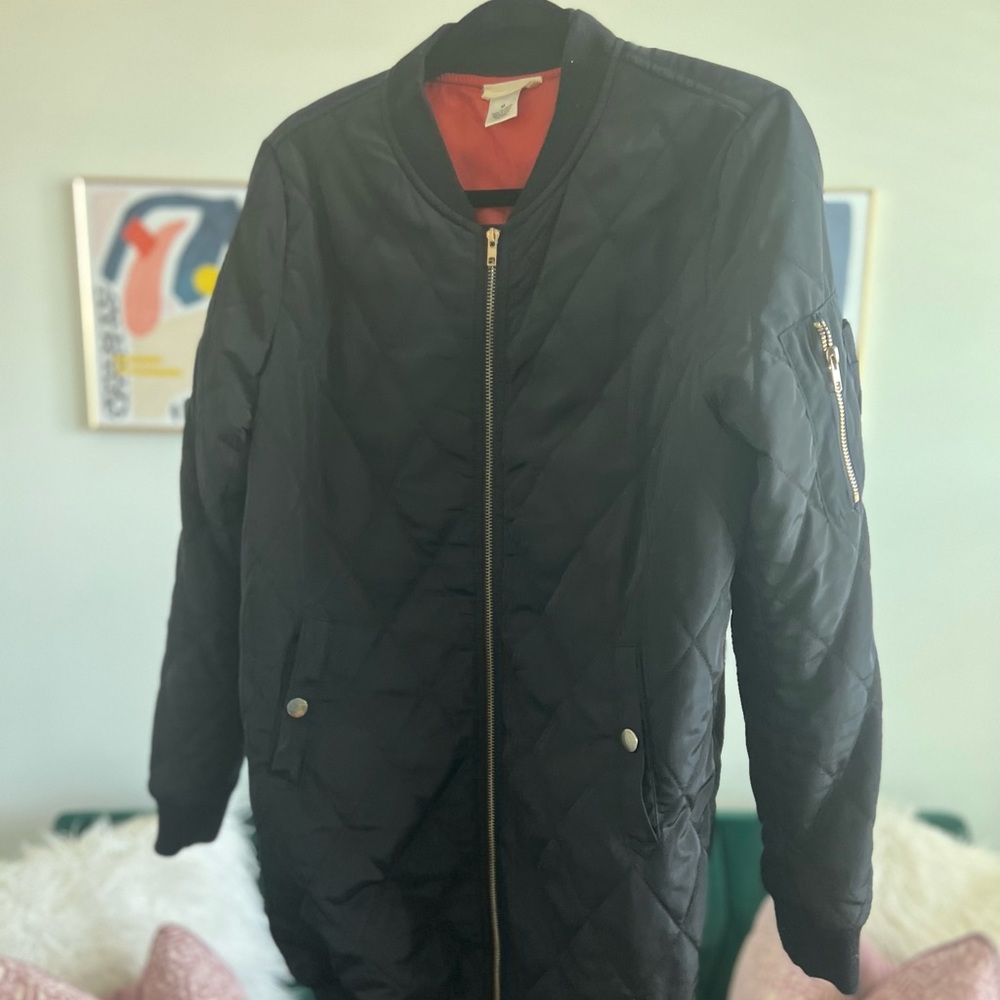 Long, over-sized Bomber jacket. Fits true to size.